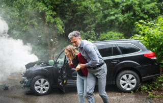 A Mature Man Helping A Young Woman To Walk After A Car Accident.