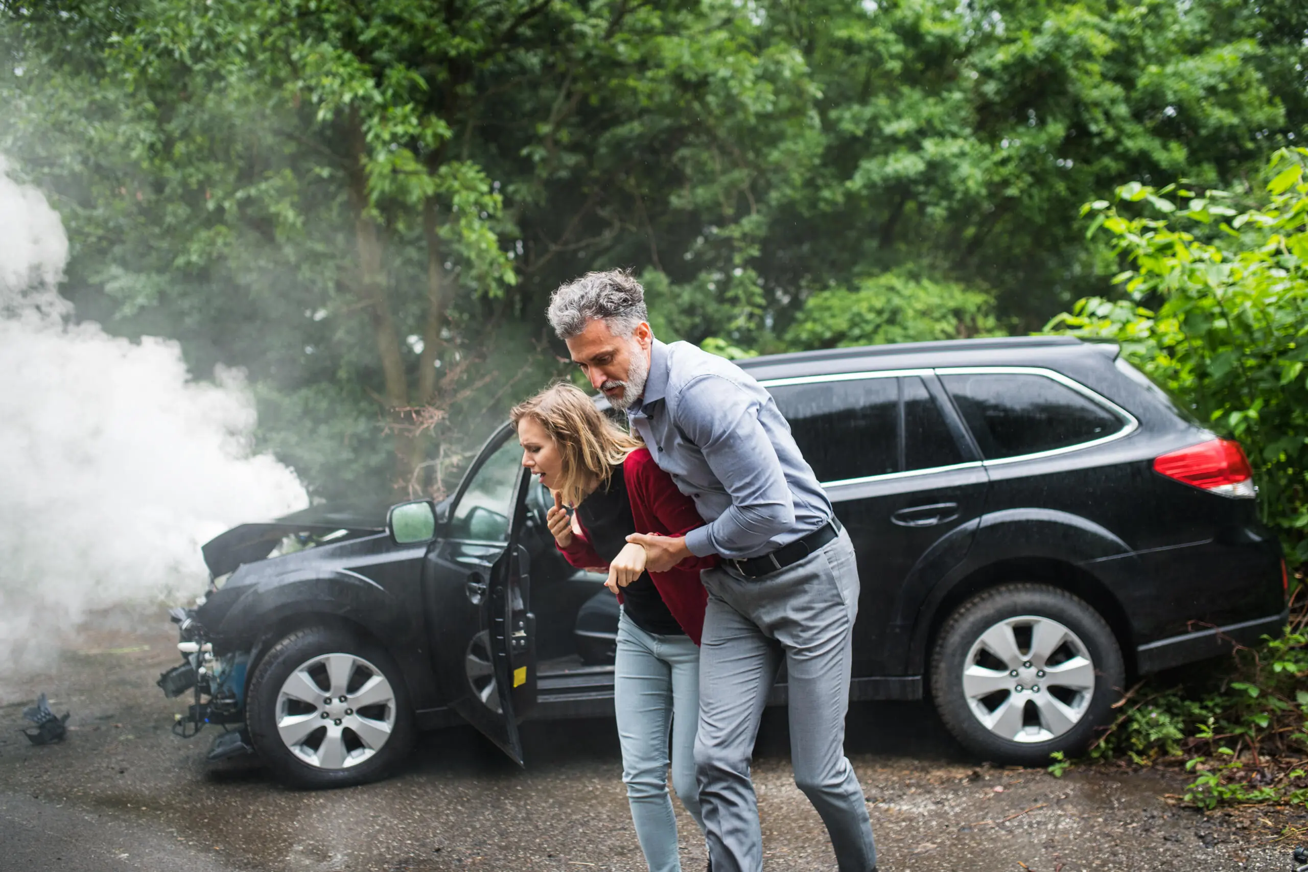 A Mature Man Helping A Young Woman To Walk After A Car Accident.